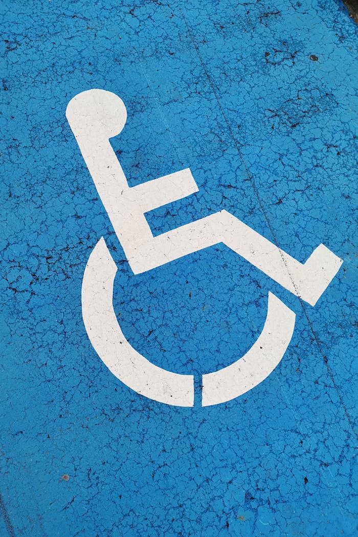 service-01 Parking space with wheelchair symbol on blue background for accessibility.